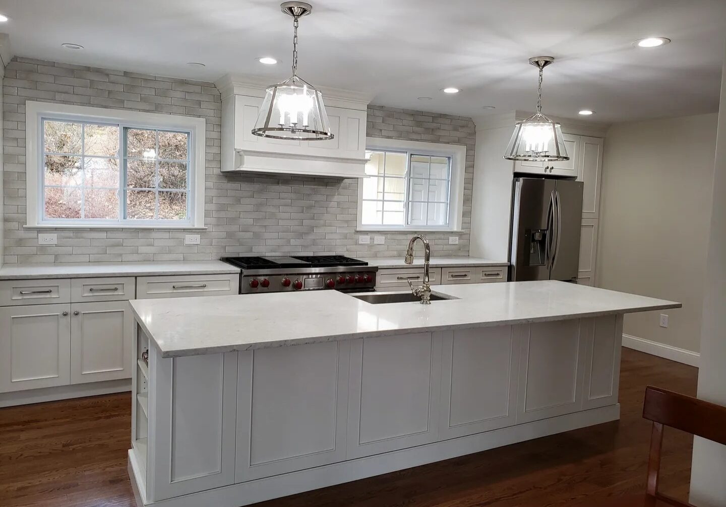 Counter island in a kitchen with white cabinets and wooden flooring